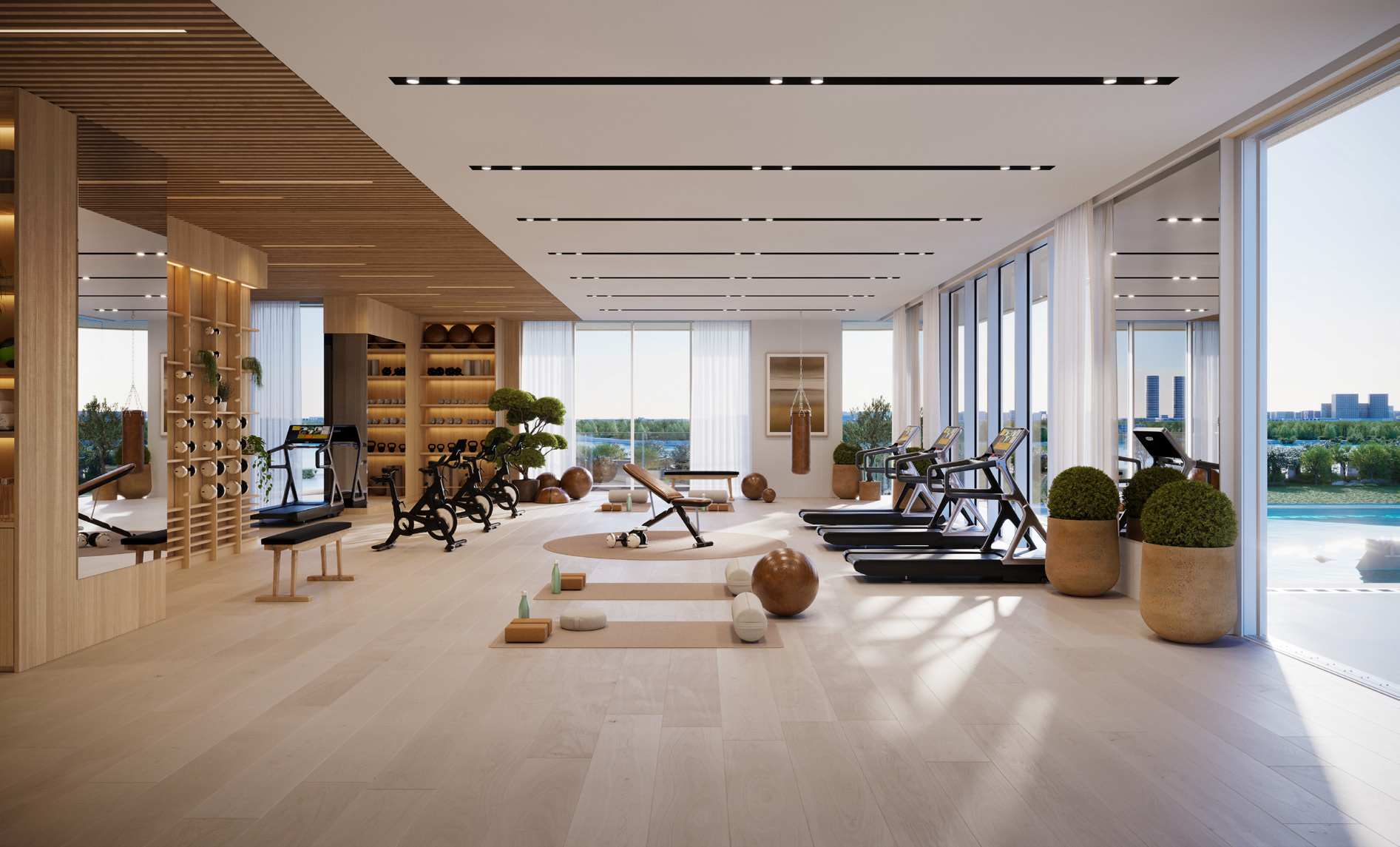 Light-filled gym with treadmills, bikes and yoga mats beside the pool