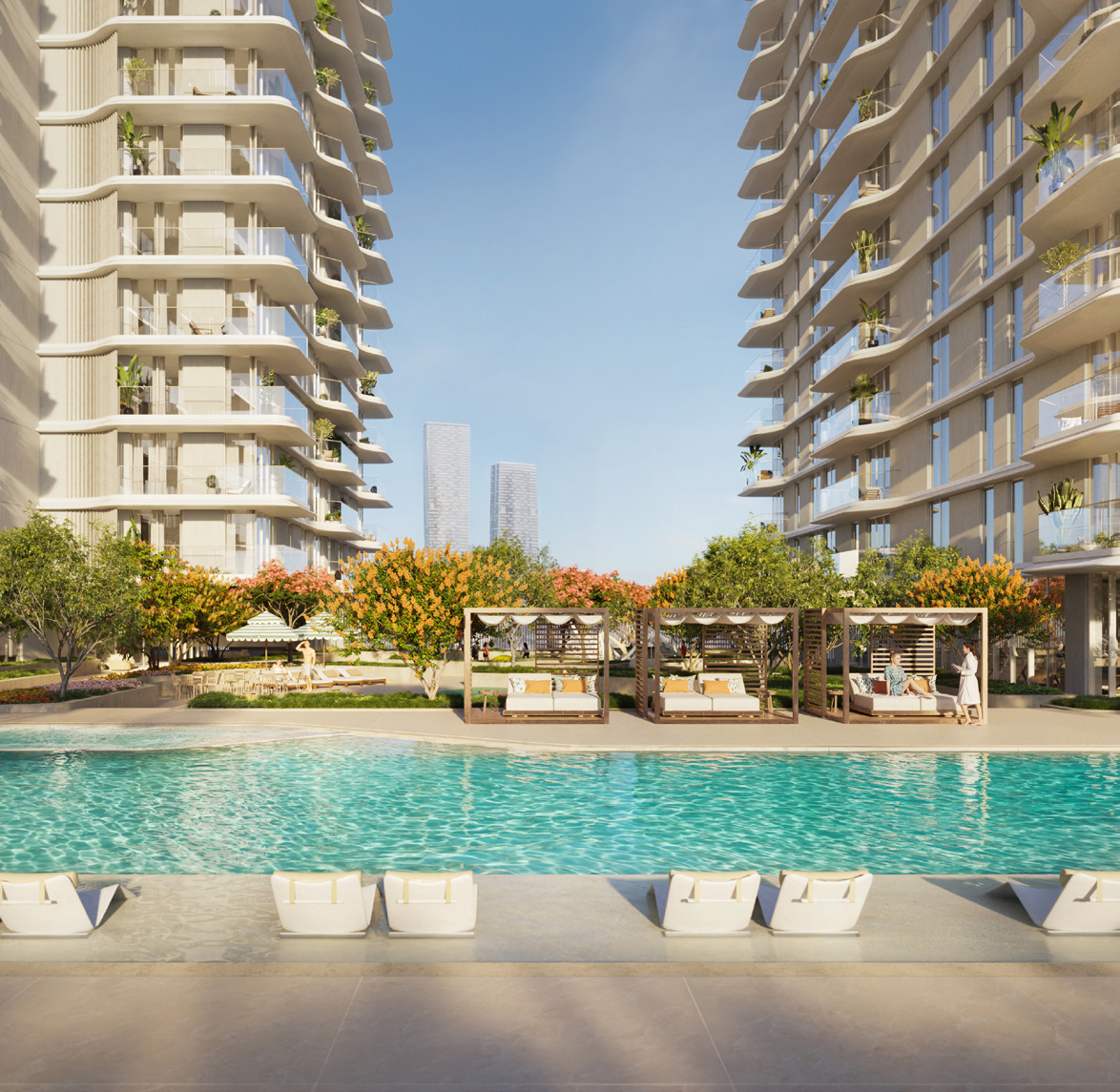 Pool with cabanas and flowering trees between the two towers